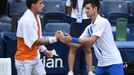 Sep 6, 2020; Flushing Meadows, New York, USA; Novak Djokovic of Serbia shakes hands with Pablo Carreno Busta of Spain after being defaulted for striking a lines person wi