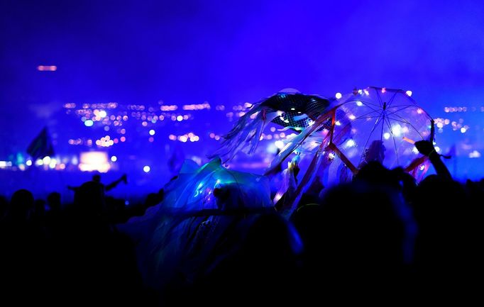 Revellers dance as The Who perform on the Pyramid stage at Worthy Farm in Somerset during the Glastonbury Festival