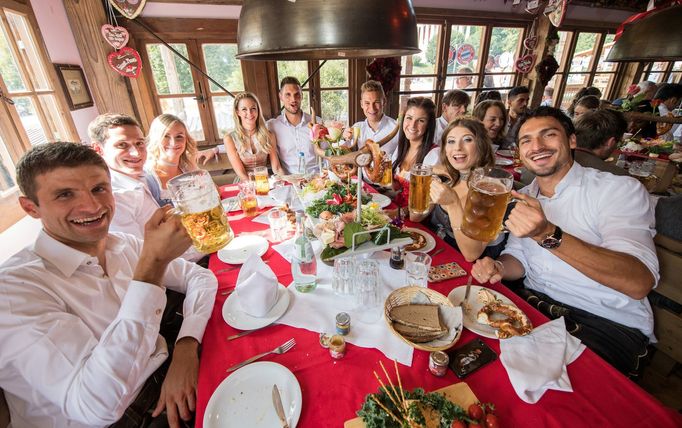 FC Bayern Munich's players and their spouses pose during their visit at the Oktoberfest in Munich