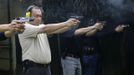 Jaime "Jimmy" Santiago (L - not in picture), a lower court judge in Manila, and fellow court judges fires their service pistol during shooting practice at a police firing range in Manila March 6, 2013. Santiago, a former police officer who headed a special weapons and tactics (SWAT) unit, favours arming Filipino judges to protect themselves from disgruntled litigants who can't accept decisions and criminal syndicates whose members were sent to jail. There had been cases of shootings inside courtrooms. In photo from L-R: Judge court Jaime Santiago, Judge court Emilio Legazpi III, Judge coourt Jose Lorenzo Dela Rosa and Judge court Armando Yanga. Picture taken March 6, 2013. REUTERS/Romeo Ranoco (PHILIPPINES - Tags: POLITICS CRIME LAW) Published: Dub. 4, 2013, 11:16 dop.