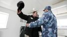 An officer searches an inmate at a control point between work and residential zones at a high-security male prison camp outside Russia's Siberian city of Krasnoyarsk May 14, 2013. High-security male prison camp number 17 is intended to house male inmates who are serving a sentence for the first time, and have been convicted for serious crimes. Prisoners at the facility work in wood and metal processing shops, manufacture furniture, sew clothes and do other kinds of work. They can also take part in educational, sport and cultural programs. Picture taken May 14, 2013. REUTERS/Ilya Naymushin (RUSSIA - Tags: CRIME LAW SOCIETY) ATTENTION EDITORS: PICTURE 10 OF 29 FOR PACKAGE 'INSIDE SIBERIA'S PRISONS' SEARCH 'ILYA PRISON' FOR ALL IMAGES Published: Čer. 19, 2013, 10:03 dop.