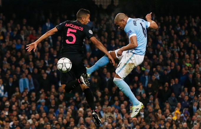 Manchester City's Fernando heads at goal as PSG's Marquinhos looks on