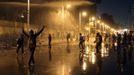 Protesters opposing Egyptian President Mohamed Mursi and the Muslim Brotherhood chant anti-government slogans while police spray water on them from inside the Presidential Palace, as some of the protesters try to break through one of the gates of the palace, in Cairo February 11, 2013. Protesters demanding the departure of Mursi clashed with police outside his palace on Monday on the second anniversary of the overthrow of veteran autocrat Hosni Mubarak. Dozens of youths threw rocks at the Ettihadiya palace after a peaceful march by thousands of demonstrators who accused Mursi's conservative Muslim Brotherhood of hijacking Egypt's democratic revolution and seeking to monopolise power. REUTERS/Asmaa Waguih (EGYPT - Tags: POLITICS CIVIL UNREST) Published: Úno. 11, 2013, 8:55 odp.