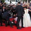 A man is arrested by security as he tries to slip under the dress of actress America Ferrera as she poses on the red carpet arriving for the screening of the film &quot;How to Train Your Dragon 2&quot