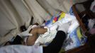 A nurse changes a child's diaper at the San Jose Hospice, in Sacatepequez, 45 km (28 miles) of Guatemala City, November 30, 2012. About 68 HIV-infected children receive free medical care at the hospice, many of them were found abandoned in markets, churches, fire stations, left neglected in hospitals or in some instances, brought in by their families who cannot afford to pay for their medical treatment. World AIDS day which falls on December 1 is commemorated across the world to raise awareness of the pandemic. REUTERS/Jorge Dan Lopez (GUATEMALA - Tags: ANNIVERSARY HEALTH) Published: Pro. 1, 2012, 1:40 dop.