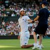 A Ball boy gives Joao Sousa of Portugal his racket back during his match against Stan Wawrinka of Switzerland at the Wimbledon Tennis Championships in London