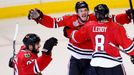 Chicago Blackhawks' Andrew Shaw (65) celebrates with teammates after scoring the game-winning goal against the Boston Bruins during triple overtime in Game 1 of their NHL