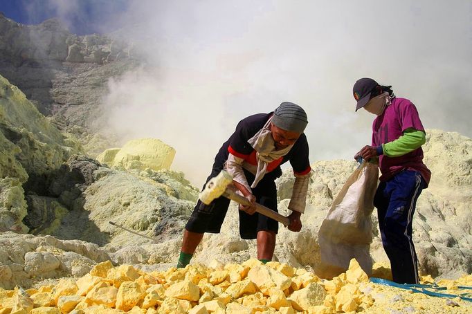 Sulfur miners risk health on Mount Ijen Jakarta, Indonesia. 24th October 2012 -- Sulfur miners break sulfur with a hammer so they can easily carry it from Mt. Kawah Ijen.