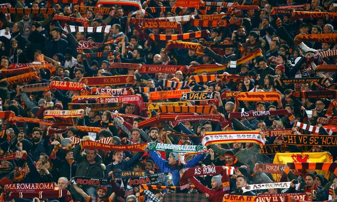 AS Roma's supporters holds their scarf during the match against Real Madrid