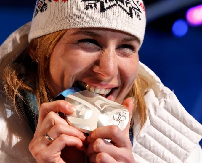 Anastasie "Nasťa" Kuzminová ochutnává stříbrnou medaili. Původem Ruska vybojovala pro Slovensko po nečekaném zlatu ze sprintu druhou biatlonovou a celkem třetí olympijskou medaili v samostatné historii.