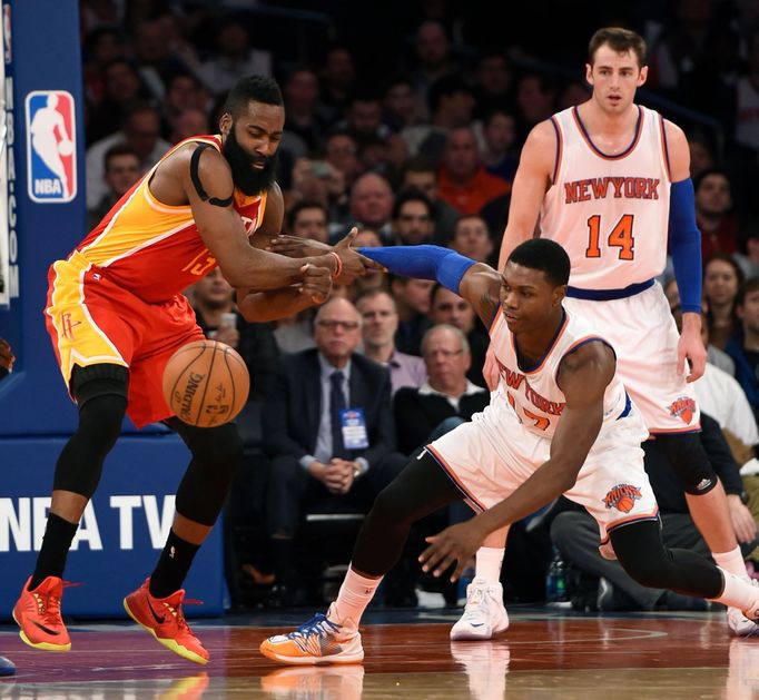 Houston Rockets guard James Harden (13) and New York Knicks forward Cleanthony Early (17) battle for a loose ball as Knicks forward Jason Smith (14) defends.