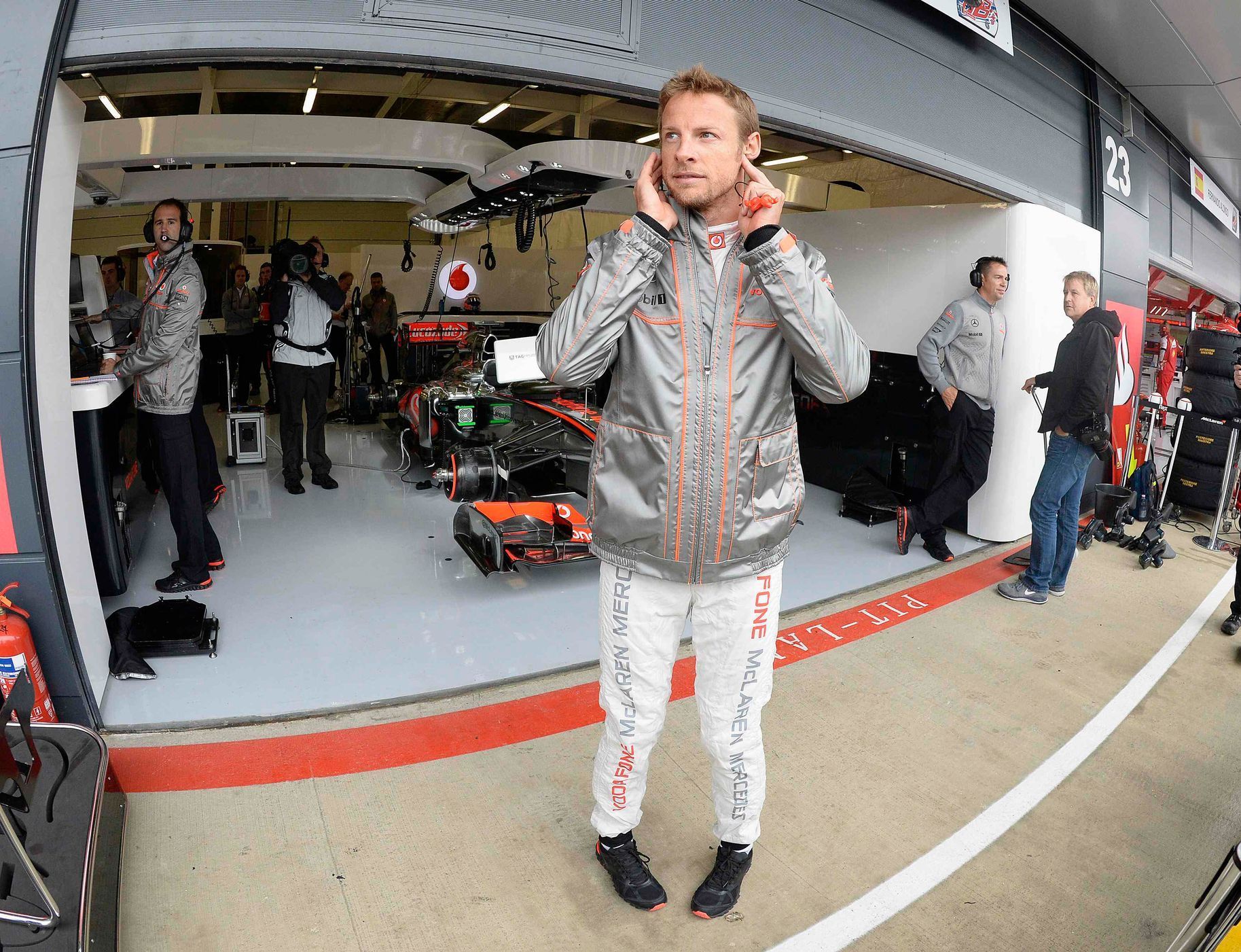 McLaren Formula One driver Button watches from pit lane duri