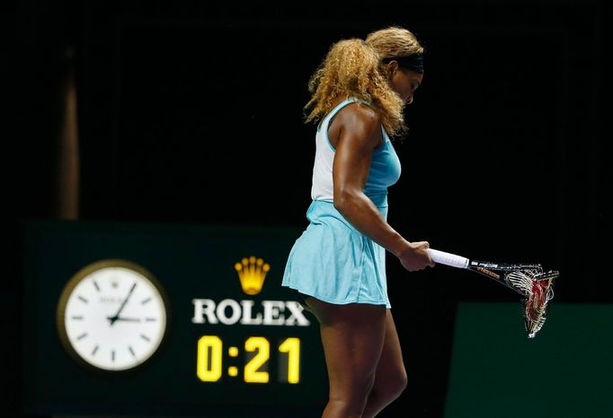 Serena Williams of the U.S. walks off the court with her second broken racquet during her WTA Finals singles semi-finals tennis match against Caroline Wozniacki of Denmar