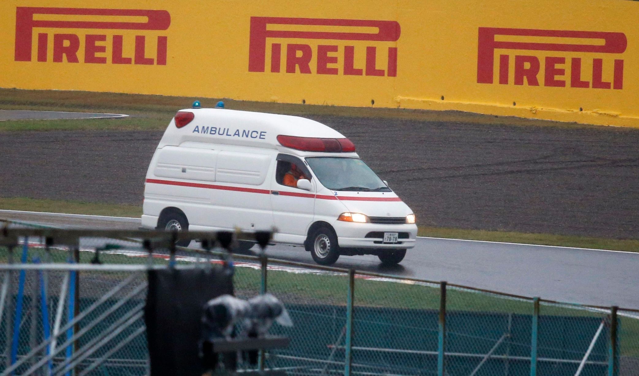 An ambulance is dispatched after the race was stopped following a crash by Marussia Formula One driver Jules Bianchi of France at the Japanese F1 Grand Prix at the Suzuka Circuit