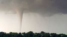 Milky White Tornado Spins Across Farmland at Sunset Original caption:A tornado is a rapidly rotating column of air, made visible by the presence of dust or debris, or in the case of this twister, the condensation of water vapor due to the lowered pressure within the column.