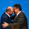 Schulz, candidate for European Commission president of Germany's Social Democratic Party (SPD), embraces SPD chairman Gabriel upon first exit polls in SPD headquarters in Berlin