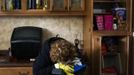 A woman weeps as she is overwhelmed by emotion after finding her family photographs inside of her heavily damaged home in the New Dorp Beach neighborhood of the Staten Island borough of New York, November 1, 2012. Deaths in the United States and Canada from Sandy, the massive storm that hit the U.S. East Coast this week, rose to at least 95 on Thursday after the number of victims reported by authorities in New York City jumped and deaths in New Jersey and elsewhere also rose. REUTERS/Lucas Jackson (UNITED STATES - Tags: ENVIRONMENT DISASTER) Published: Lis. 1, 2012, 10:20 odp.