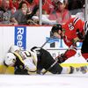 Bruins Boychuk is hit along the boards by Blackhawks' Shaw d