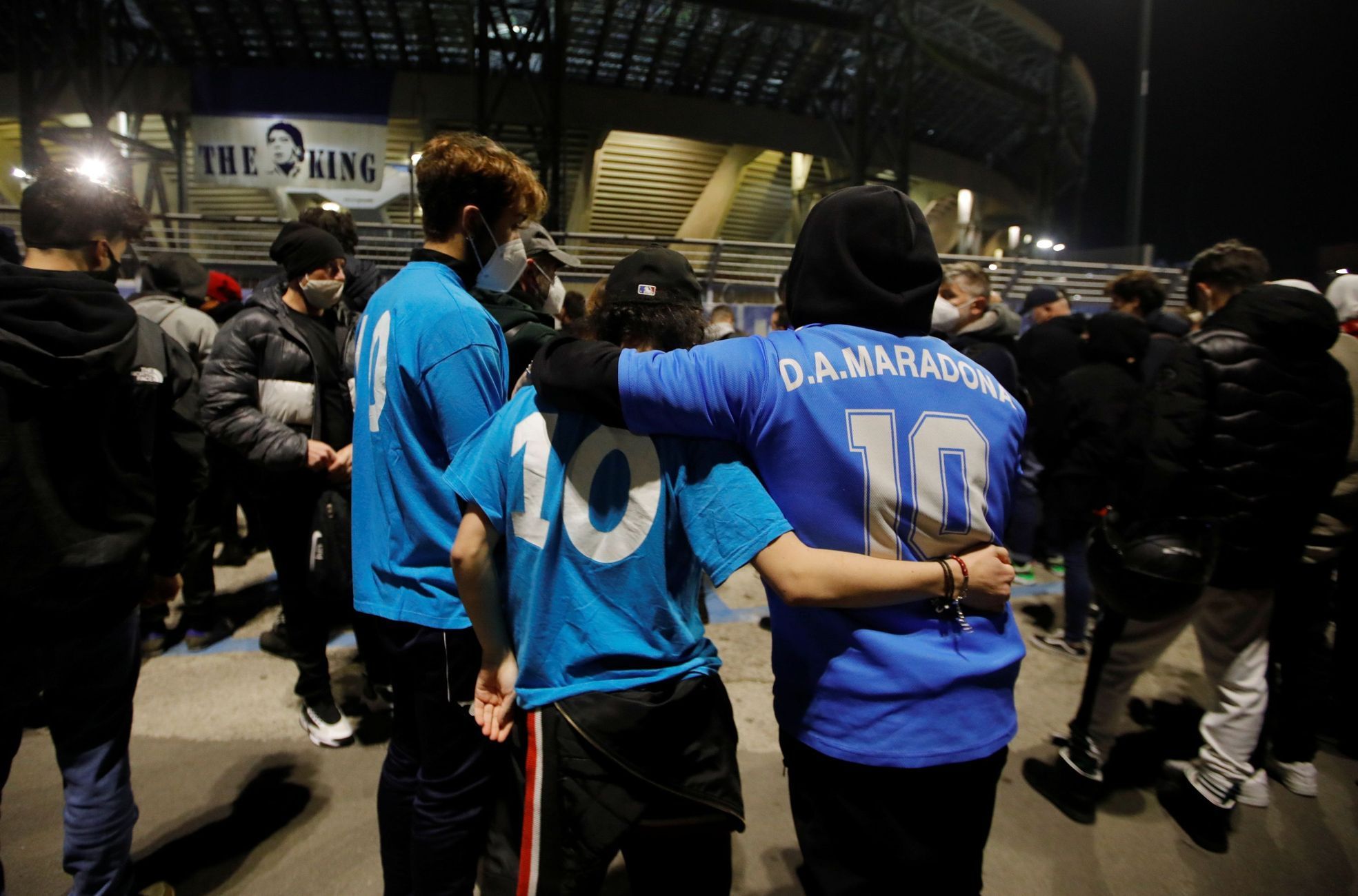 People gather to mourn the death of Argentine soccer legend Diego Maradona outside San Paolo stadium in Naples