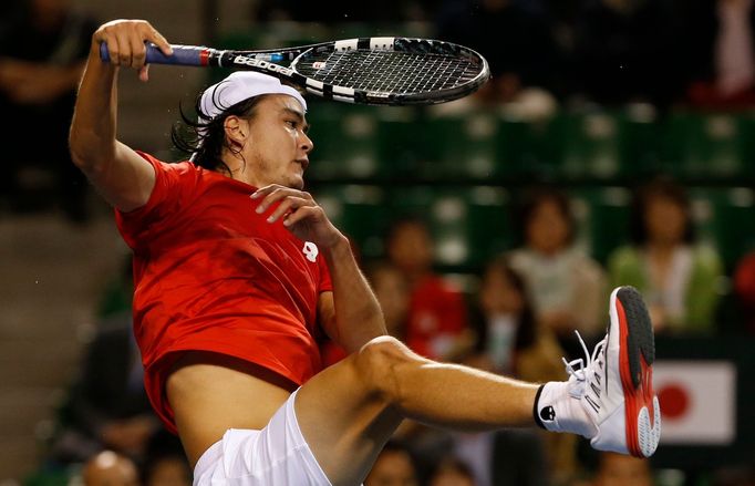 Japan's Daniel smashes a shot against Czech Republic's Rosol during their Davis Cup quarter final tennis match in Tokyo