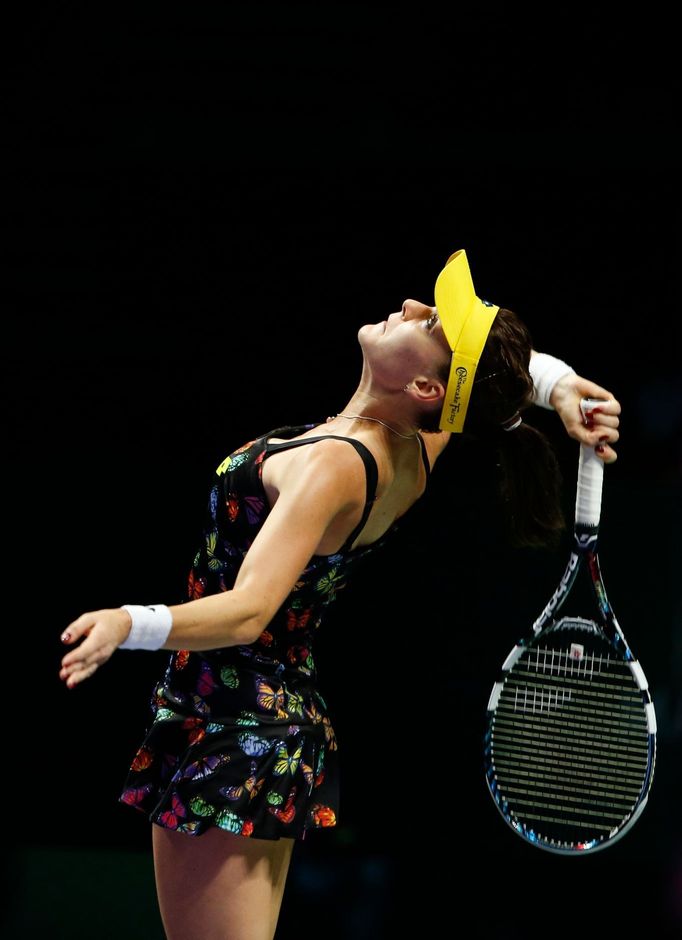 Agnieszka Radwanska of Poland serves against Petra Kvitova of the Czech Republic during their WTA Finals singles tennis match at the Singapore Indoor Stadium October 22,