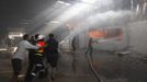 Firefighters try to extinguish a fire at a factory, which according to Palestinians was hit by an Israeli air strike in Gaza November 16, 2012. Egyptian Prime Minister Hisham Kandil, on a brief visit to the Gaza Strip on Friday, denounced Israel's attacks on the Palestinian territory and said Cairo would try to secure a ceasefire. Fighting continued along the Israel-Gaza border during Kandil's three-hour visit. REUTERS/Ahmed Zakot (GAZA - Tags: CIVIL UNREST MILITARY POLITICS) Published: Lis. 16, 2012, 9:31 dop.