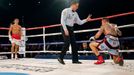 World champion Gennadiy Golovkin of Kazakhstan (L) looks at Martin Murray of England (R), after knocking him down, during the WBA-WBC-IBO Middleweight World Championship