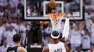 Miami Heat's LeBron James (R) shoots a three point basket while being guarded by San Antonio Spurs' Danny Green during the sceond quarter in Game 7 of their NBA Finals ba