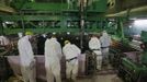 Workers wearing protective suits and masks are seen next to the spent fuel pool inside the Common Pool Building, where all the nuclear fuel rods will be stored for decommissioning, at Tokyo Electric Power Co. (TEPCO)'s tsunami-crippled Fukushima Daiichi nuclear power plant in Fukushima prefecture, March 6, 2013, ahead of the second-year of anniversary of the March 11, 2011 tsunami and earthquake. Members of the media were allowed into the plant on Wednesday ahead of the second-year anniversary of the tsunami and earthquake, which triggered the world's worst nuclear crisis since Chernobyl. REUTERS/Issei Kato (JAPAN - Tags: DISASTER ANNIVERSARY ENERGY) Published: Bře. 6, 2013, 9:43 dop.