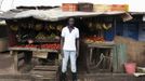 Karl Moi Okoth, a 27 year-old vegetable and fruit seller, poses for a picture in front of his makeshift shop in Nairobi's Kibera slum in the Kenyan capital April 30, 2012. Okoth studied psychology and chemistry at Day Star University where he received a degree in psychology. He has been searching for permanent employment for four years but has decided to make a living working in the slums for the last eight months.