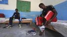 Somali athletes remove their shoes inside their room after a training session as part of their preparations for the 2012 London Olympic Games in Somalia's capital Mogadishu in this March 14, 2012 file photo. Training in a bullet-riddled stadium where the remains of a rocket propelled grenade lies discarded on the track's edge counts as progress for Somali Olympic hopeful Mohamed Hassan Mohamed. A year ago, Mogadishu's Konis stadium was a base for Islamist militants and a work out meant at times running through the streets, dodging gun-fire and mortar shells in one of the world's most dangerous cities. To match OLY-SOMALIA-HOPES/ REUTERS/Feisal Omar/Files (SOMALIA - Tags: SPORT ATHLETICS OLYMPICS) Published: Čer. 11, 2012, 6:36 dop.