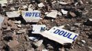 The broken sign of a hotel hit by French air strikes lies on the ground in Douentza January 29, 2013. The hotel was used as a base for Islamists and was hit by French air strikes over a week ago. REUTERS/Joe Penney (MALI - Tags: CIVIL UNREST POLITICS CONFLICT) Published: Led. 29, 2013, 1:47 odp.