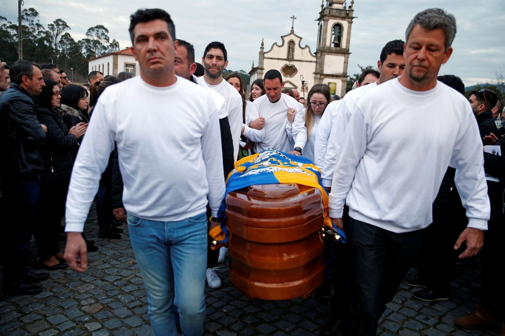 The coffin of Portuguese motorcycle rider Paulo Goncalves is carried by relatives during the funeral procession at the village of Gemeses