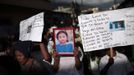 People hold a picture of 8-year-old Evelyn Yanisa Saquij Bin on the streets of Tactic, in the Alta Verapaz region, some 189 km (117 miles) from Guatemala City, September 14, 2012. Angry villagers in Guatemala killed a man by setting fire to him after he hacked Saquij Bin and 13-year-old Juan Armando Coy Cal to death with a machete in a school on September 12. The two children were buried today in a municipal cemetery. REUTERS/Jorge Dan Lopez (GUATEMALA - Tags: CRIME LAW SOCIETY TPX IMAGES OF THE DAY) Published: Zář. 15, 2012, 4:30 dop.