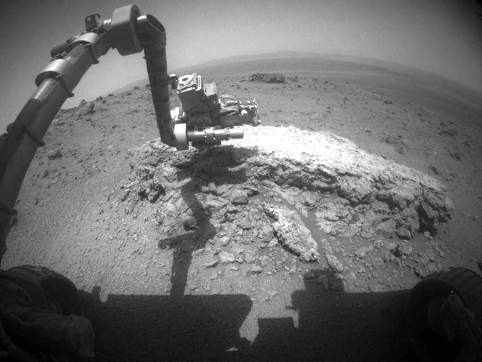 Opportunity at Work Examining 'Tisdale 2,' Sol 2695 NASA's Mars Exploration Rover Opportunity used its front hazard-avoidance camera to take this picture showing the rover's arm extended toward a light-toned rock, "Tisdale 2," during the 2,695th Martian day, or sol, of the rover's work on Mars (Aug. 23, 2011). Tisdale 2 is about 12 inches (30 centimeters) tall. The rover used two instruments on the robotic arm, the microscopic imager and the alpha particle X-ray spectrometer, to examine Tisdale 2. In this image, the turret at the end of the arm is positioned so that the microscopic imager is facing the rock. Tisdale 2 and other rocks on the ground beyond it were apparently ejected by the impact that excavated a 66-foot-wide (20-meter-wide) crater, called "Odyssey," which is nearby to the left (north) of this scene. Odyssey and these rocks are on a low ridge called "Cape York," which is a segment of the western rim of Endeavour crater. Endeavour is about 14 miles (22 kilometers) in diameter. Portions of the interior and eastern rim of Endeavour are visible near the top of this image. Image Credit: NASA/JPL-Caltech