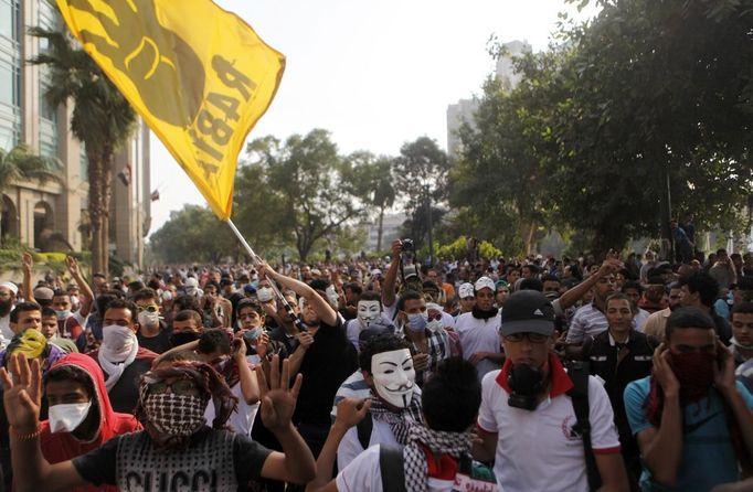 Members of the Muslim Brotherhood and supporters of ousted Egyptian President Mohamed Mursi shout slogans against the military and interior ministry in front of riot police during clashes along a road at Kornish El Nile which leads to Tahrir Square during a celebration commemorating Egypt's 1973 war with Israel in Cairo October 6, 2013. Thousands of supporters of deposed Egyptian President Mohamed Mursi marched through Cairo on Sunday towards Tahrir Square, where pro-army supporters gathered to celebrate the anniversary of an attack on Israeli forces in 1973.