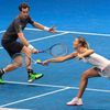 Sharapova and Murray of the Manila Mavericks hit a return to Mladenovic and Zimonjic of the UAE Royals during their mixed doubles tennis match at the IPTL competition in Manila