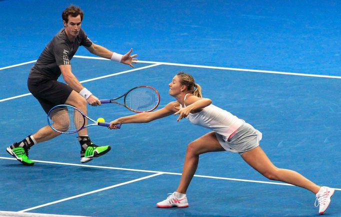 Maria Sharapova (R) and Andy Murray (L) of the Manila Mavericks hit a return to Kristina Mladenovic and Nenad Zimonjic of the UAE Royals during their mixed doubles tennis