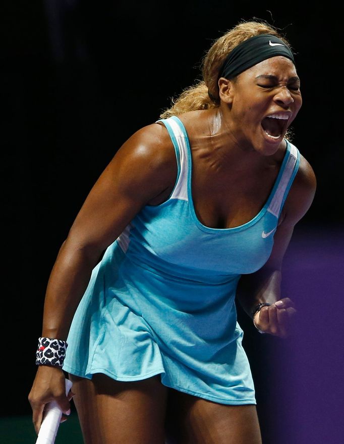 Serena Williams of the U.S. shouts as she wins a point against Caroline Wozniacki of Denmark during their WTA Finals singles semi-finals tennis match at the Singapore Ind