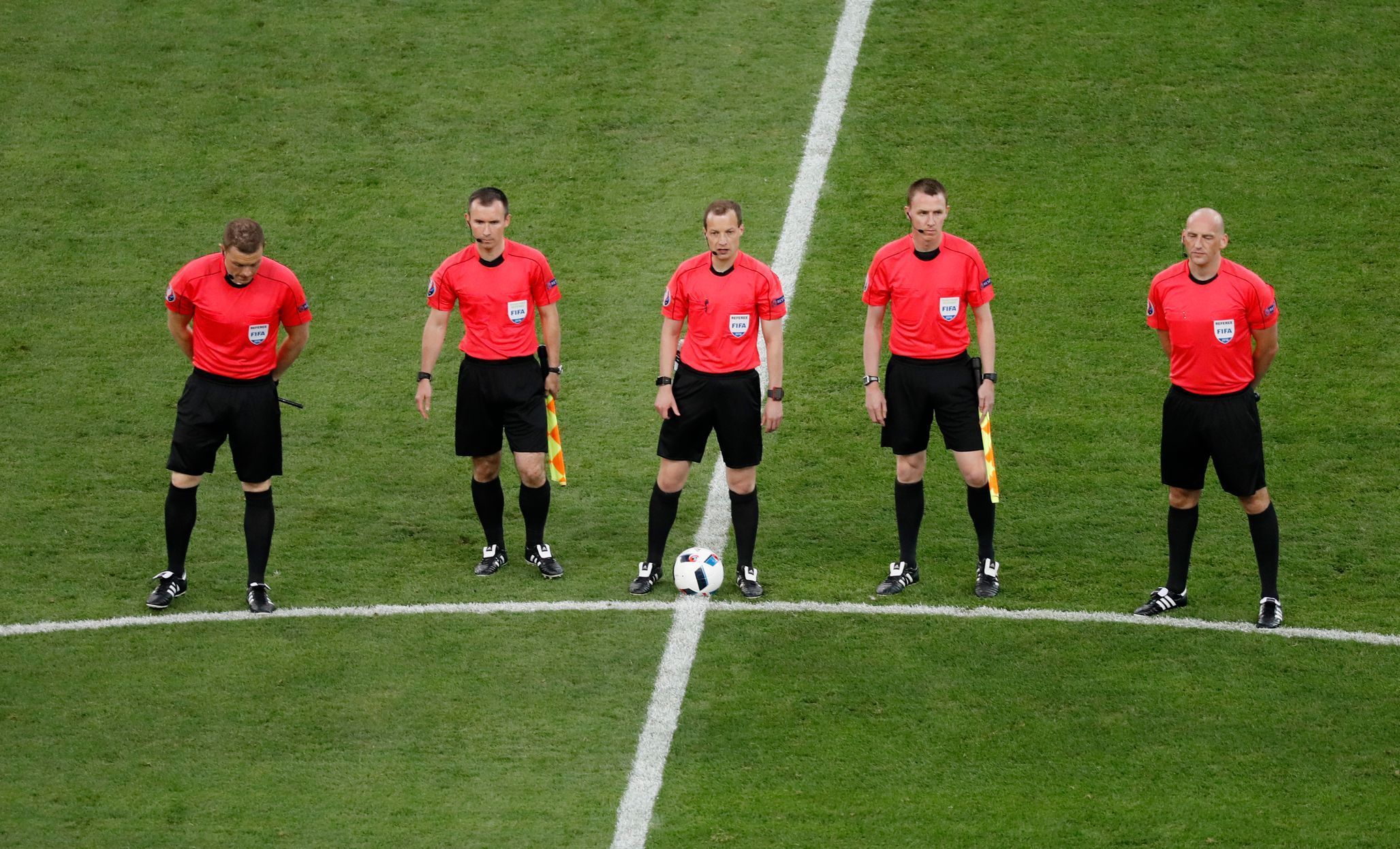 Referee William Collum and assistants line up before the game