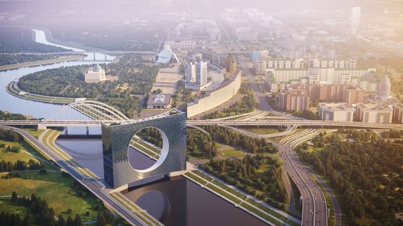 Futuristická budova spojuje parky na obou stranách řeky. Díky prázdnému kruhu navíc nestíní ve výhledů řidičům.