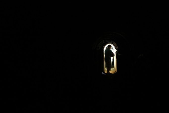 A member of the media stands inside a tunnel exposed by the Israeli military, just outside the southern Gaza Strip