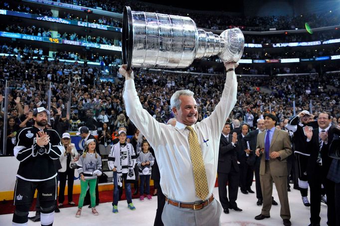 Jun 13, 2014; Los Angeles, CA, USA; Los Angeles Kings head coach Darryl Sutter hoists the Stanley Cup after defeating the New York Rangers game five of the 2014 Stanley C