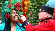 Londýn, Velká Británie: Claire Myers-Lamptey v květinové čelence pózuje s válečným veteránem během návštěvy slavné Chelsea Flower Show. Setkání tradice a rozkvetlé elegance v srdci Londýna.