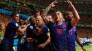 Arjen Robben of the Netherlands (C) is congratulated by his teammates after he scored a goal against Spain during their 2014 World Cup Group B soccer match at the Fonte N