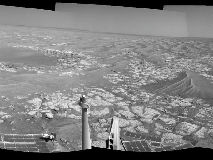 Opportunity's Surroundings After Sol 2363 Drive This mosaic of images from the navigation camera on NASA's Mars Exploration Rover Opportunity shows surroundings of the rover's location following an 81-meter (266-foot) drive during the 2,363rd Martian day, or sol, of Opportunity's mission on Mars (Sept. 16, 2010). The camera took the component images for this 360-degree panorama during sols 2363 to 2365. The terrain includes light-toned bedrock and darker ripples of wind-blown sand. For scale, the distance between the parallel wheel tracks in the right half of the image is about 1 meter (about 40 inches). This view is presented as a cylindrical projection. Image Credit: NASA/JPL-Caltech