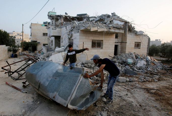 Palestinians inspect the damage after Israeli troops demolished the family house of Palestinian assailant Khalid Makhamreh in the West Bank village of Yatta, south of Heb