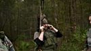 A member of the North Florida Survival Group takes a break from performing an enemy contact drill to call his wife during a field training exercise in Old Town, Florida, December 8, 2012.The group trains children and adults alike to handle weapons and survive in the wild. The group passionately supports the right of U.S. citizens to bear arms and its website states that it aims to teach "patriots to survive in order to protect and defend our Constitution against all enemy threats". Picture taken December 8, 2013. REUTERS/Brian Blanco (UNITED STATES - Tags: SOCIETY POLITICS) ATTENTION EDITORS: PICTURE 15 OF 20 FOR PACKAGE 'TRAINING CHILD SURVIVALISTS' SEARCH 'FLORIDA SURVIVAL' FOR ALL IMAGES Published: Úno. 22, 2013, 1:05 odp.