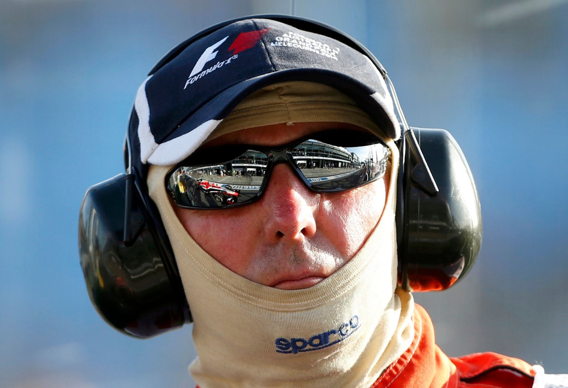 Marussia Formula One driver Chilton of Britain is reflected in the sunglasses of a race official during the second practice session of the Australian F1 Grand Prix in Melbourne