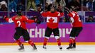 Canada's Marie-Philip Poulin (C) celebrates her gold medal winning goal against Team USA with teammates Meghan Agosta-Marciano (L) and Hayley Wickenheiser in overtime in